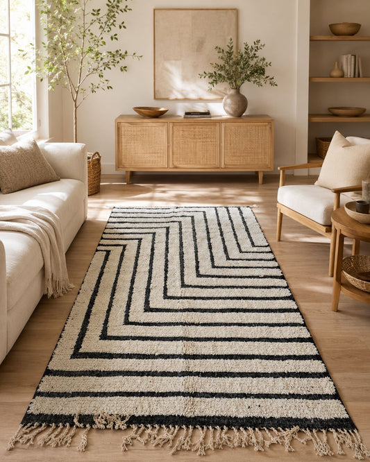 Ivory and black geometric Moroccan rug styled in a modern living room.
