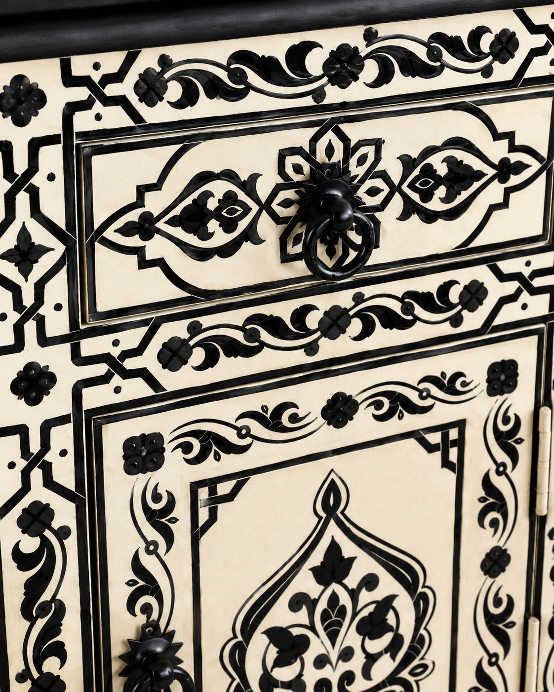 Close-up of hand-painted Moroccan patterns and black metal ring pulls