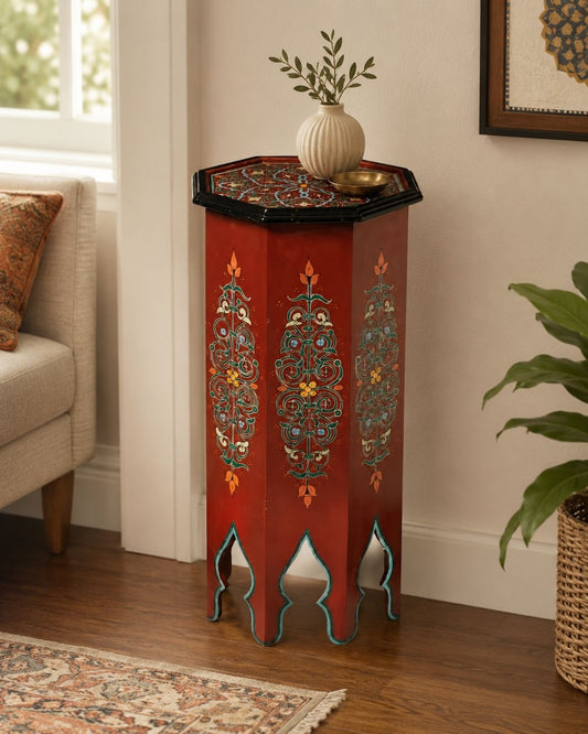 Octagonal Moroccan wooden table featuring detailed floral patterns and traditional arched legs.