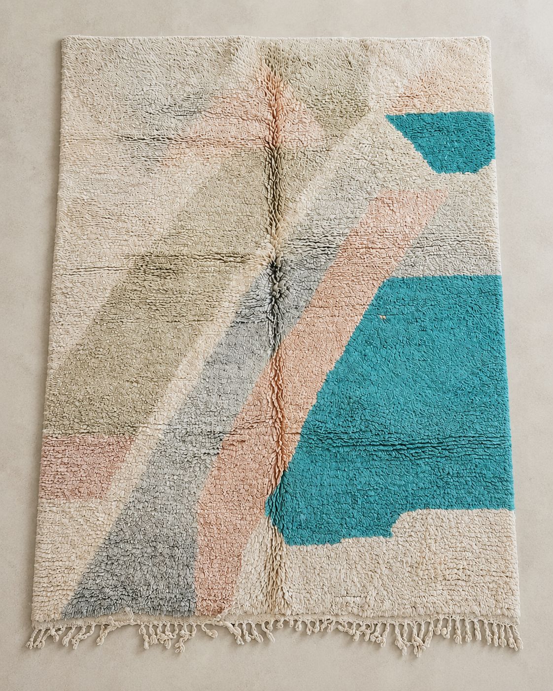 Front view of a cream Moroccan rug with teal, pink and gray color blocks. 
