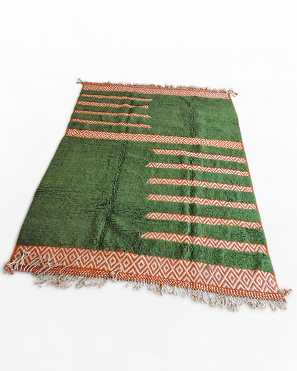 Cream tassel fringe along the edge of the handmade Moroccan rug.