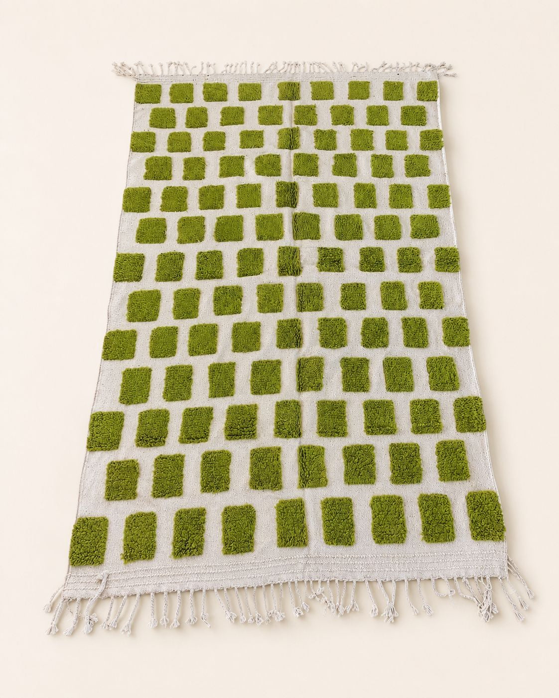 Direct, flat top-down view of the cream and green block pattern Moroccan wool rug showcasing its rectangular symmetry.