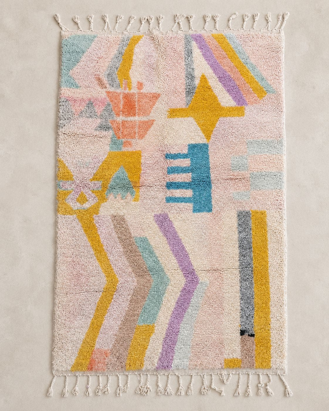 Front view of a cream and blush Moroccan rug with colorful abstract shapes. 