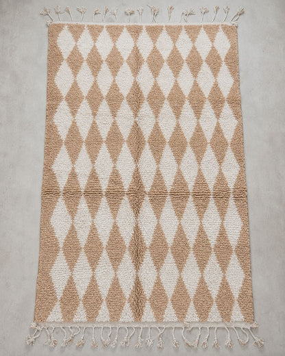 Close-up of the textured wool surface and beige and ivory pattern. 