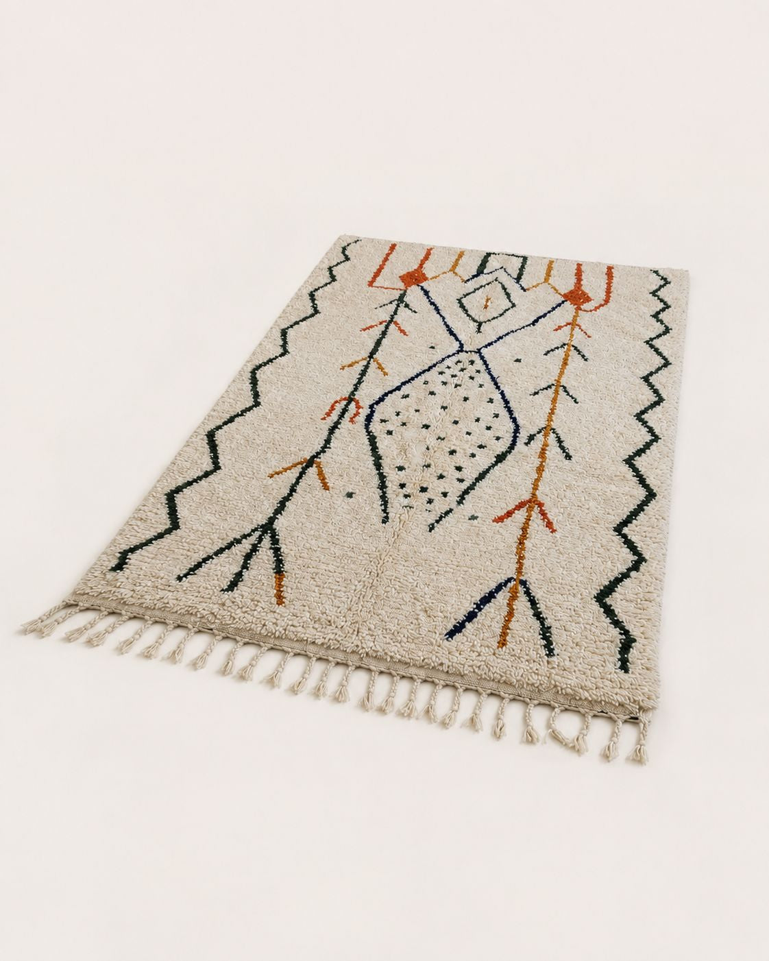 Detailed macro view highlighting the plush 100% natural wool pile and texture of the handmade rug.