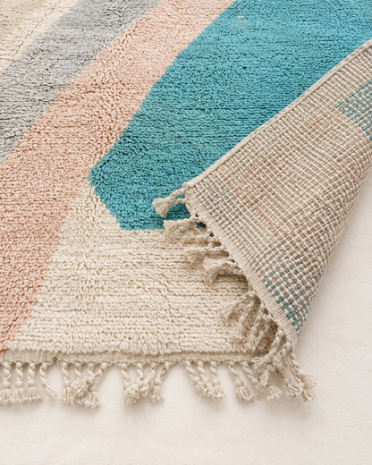 Hand-finished tassel fringe along the edge of the Moroccan wool rug. 