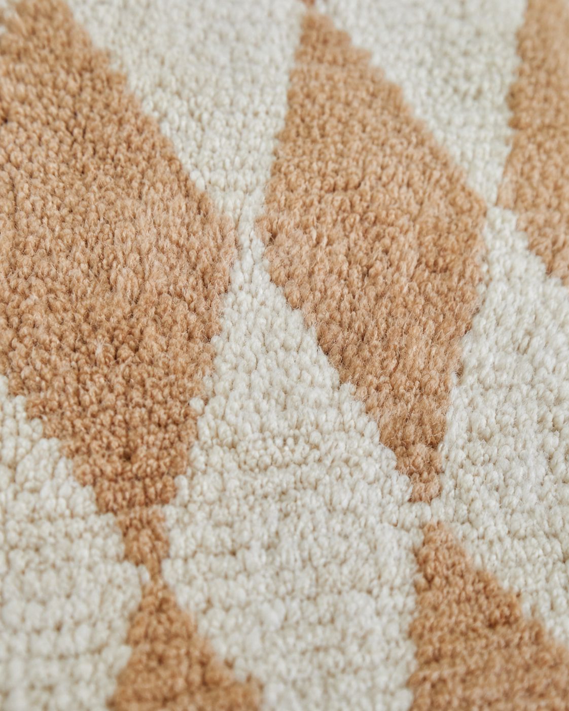 Hand-finished tassel fringe along the edge of the Moroccan rug. 