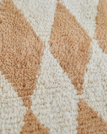 Hand-finished tassel fringe along the edge of the Moroccan rug. 