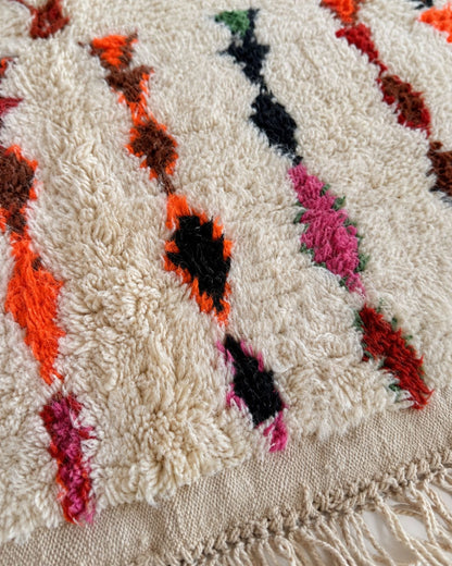 Knotted tassel fringe along the edge of the Moroccan rug. 