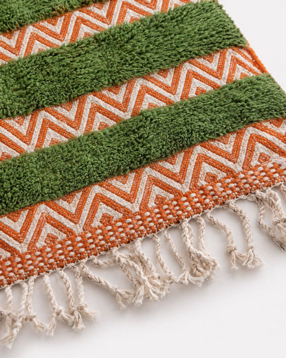 Cream tassel fringe along the edge of the handmade Moroccan rug. 