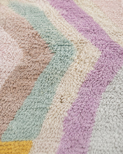Close-up of the textured rug surface and pastel geometric detailing. 