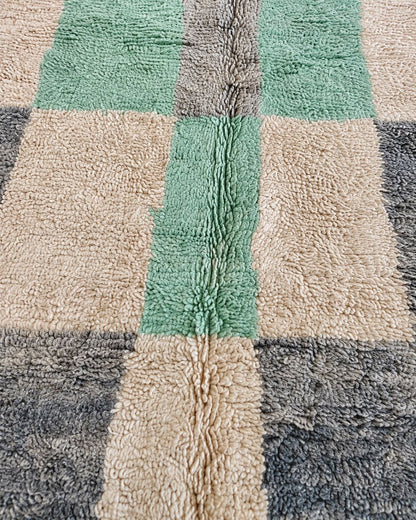 Close-up of the faded wool texture and mint green checkered detailing. 
