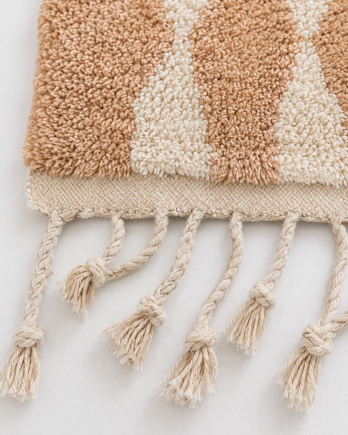 Back of the Moroccan rug showing its handmade construction and finished edges. 