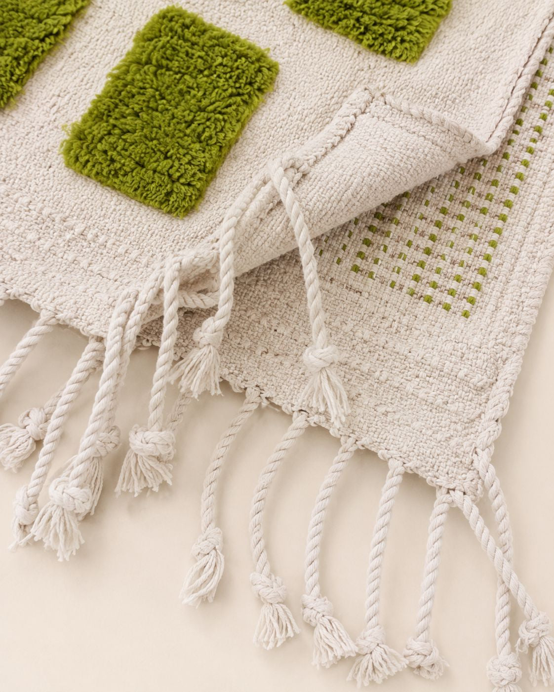 Detailed view of the traditional braided off-white fringe finish along the edge of the Moroccan rug.