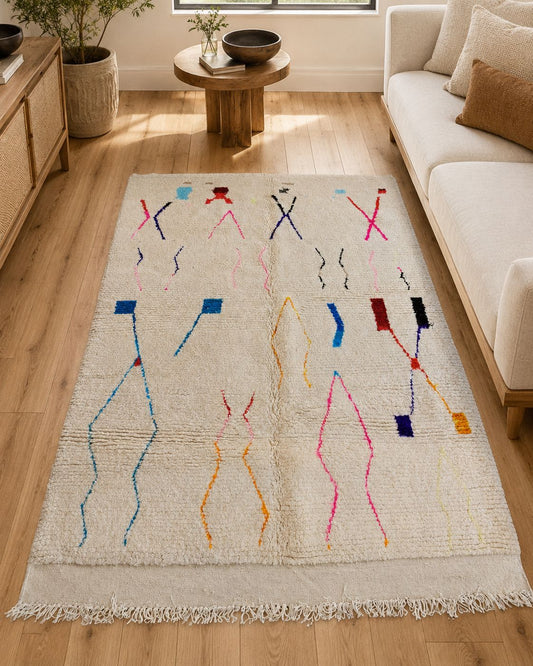 Multicolor ivory Moroccan rug styled in a warm contemporary living room. 