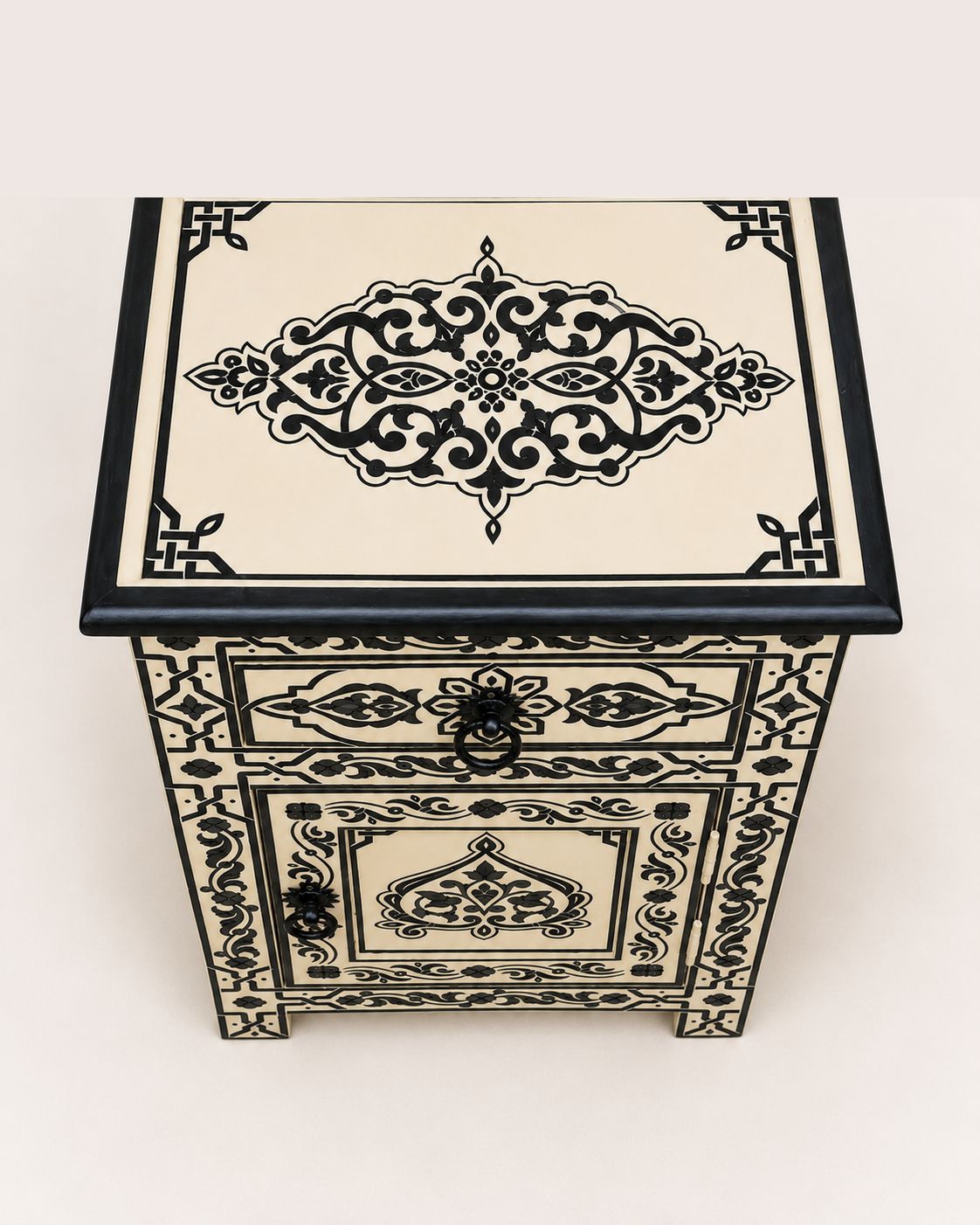 Decorative wooden box with intricate black patterns on a white background