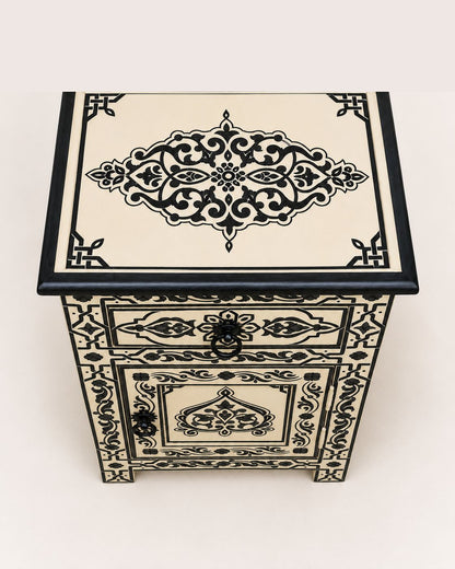 Decorative wooden box with intricate black patterns on a white background
