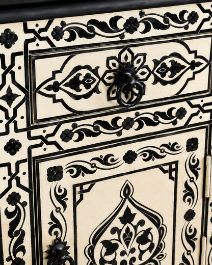 Close-up of hand-painted Moroccan patterns and black metal ring pulls 