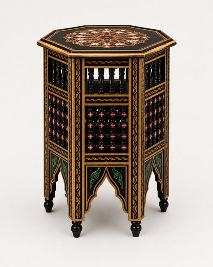 An ornate octagonal side table with a black lacquered finish, decorated with intricate gold, red, and green geometric and floral patterns, shown on a light gray background.