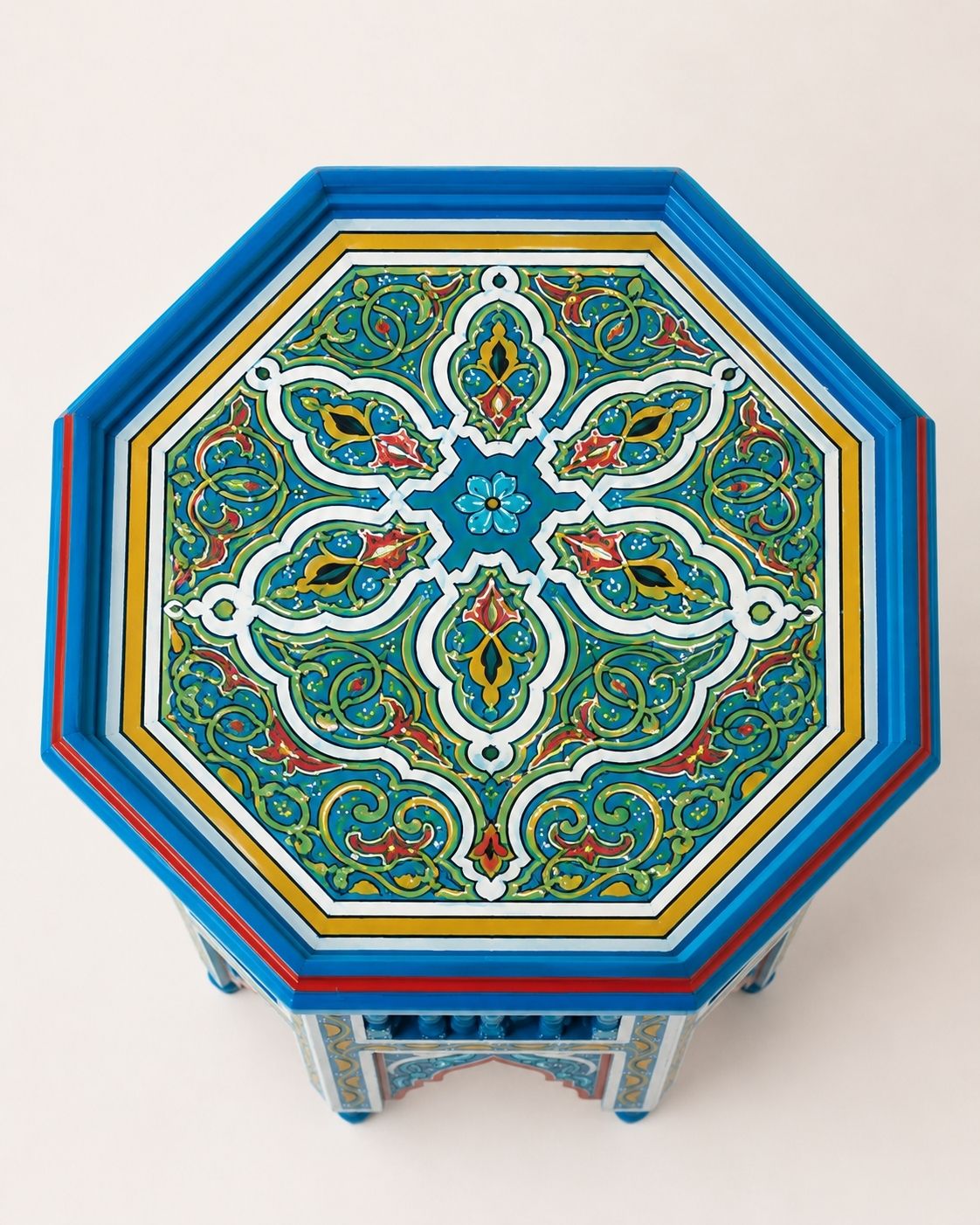Artisan Moroccan end table with traditional geometric patterns and carved wood details.