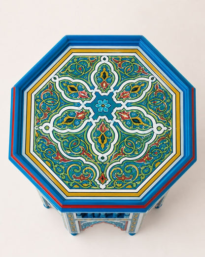 Artisan Moroccan end table with traditional geometric patterns and carved wood details.