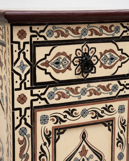 Decorative wooden drawer with intricate patterns and a black handle.