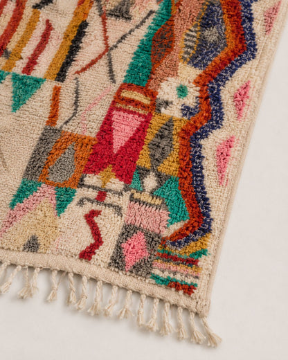 Close-up of the textured wool pile with colorful geometric details. 