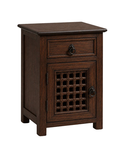Moroccan boho nightstand beside a bed with lamp and plant decor 