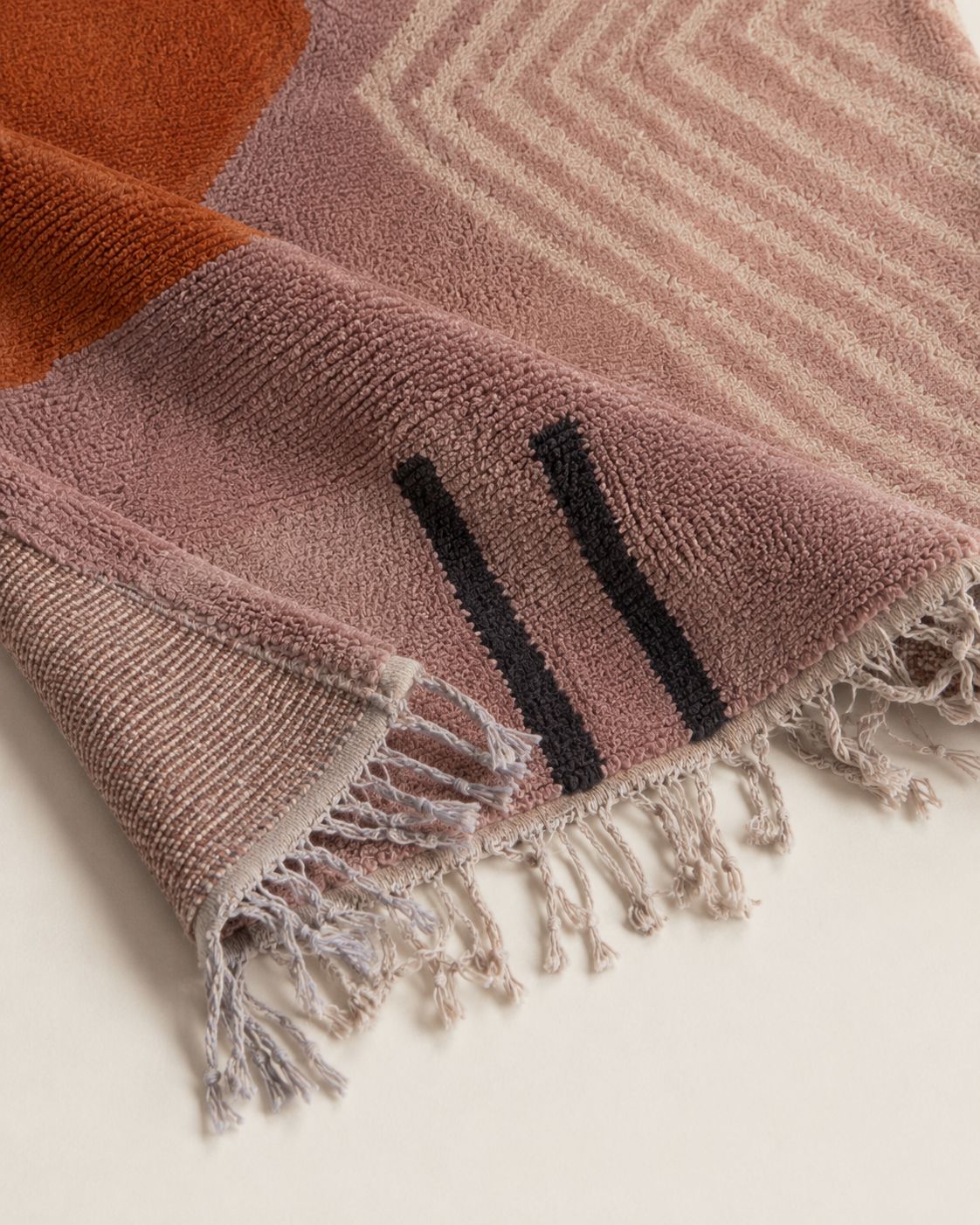Close-up of the textured wool pile and geometric pattern. 