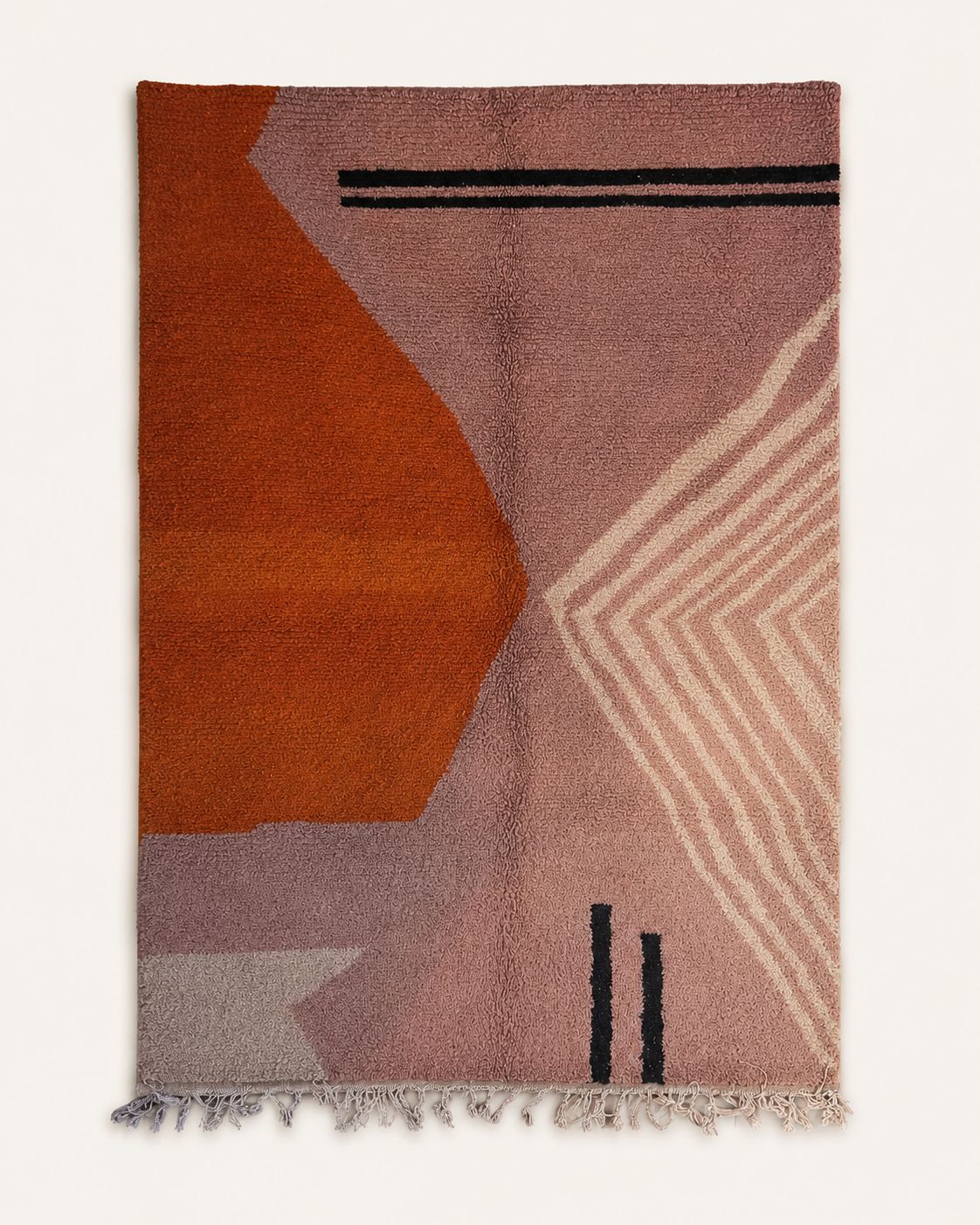 Front view of a blush pink abstract Moroccan area rug. 