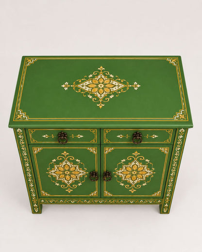 Close-up of gold hand-painted details on a green Moroccan cabinet