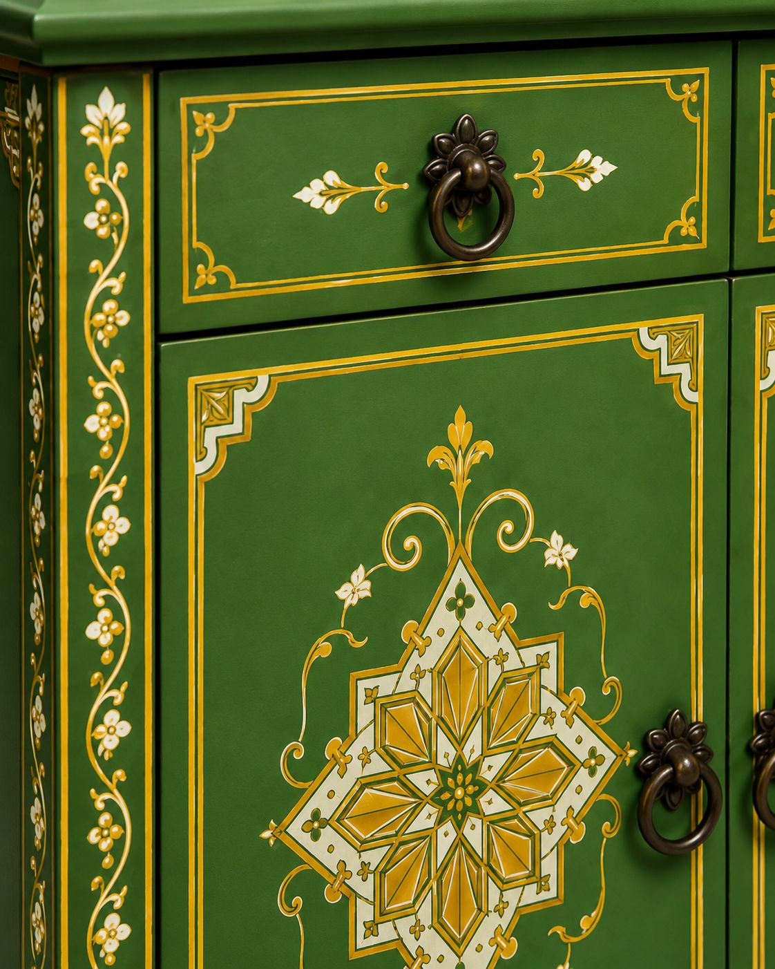 Decorative green cabinet with gold and white floral patterns and bronze handles.