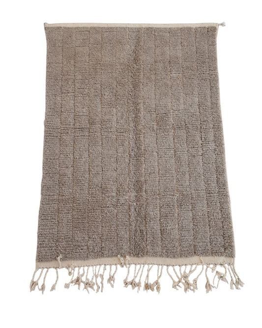 Full view of a handmade light taupe Moroccan wool rug with a textured pattern. 