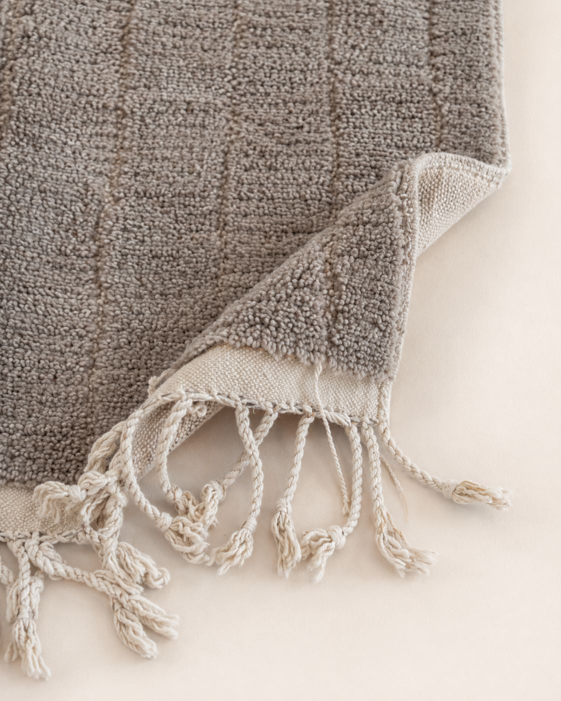 Hand-finished fringe detail on the edge of the Moroccan wool rug. 