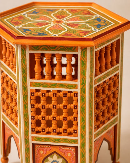 Artisan Moroccan end table featuring traditional carved wood arches and green linework.
