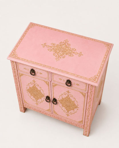 Close-up of gold geometric patterns on a pink Moroccan cabinet