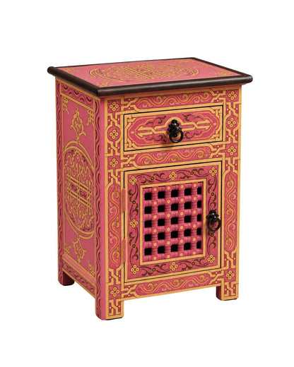 Pink and gold boho nightstand beside bed with lamp and plant decor 