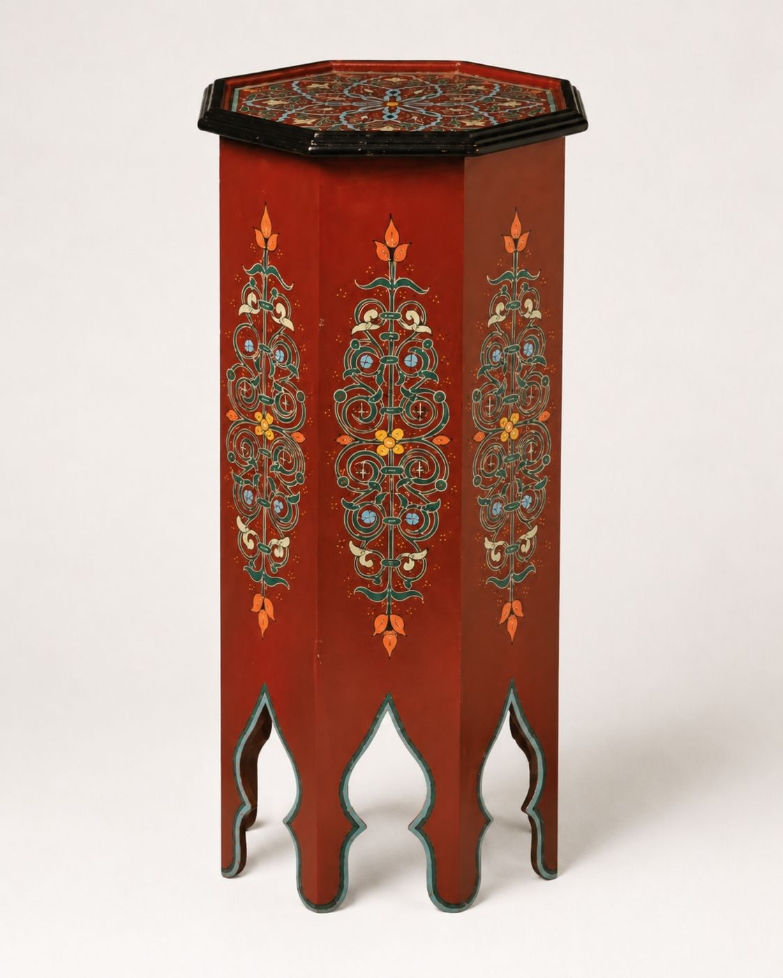 Top-down view of an octagonal Moroccan table showing intricate geometric hand-painted artwork.