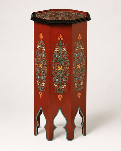 Top-down view of an octagonal Moroccan table showing intricate geometric hand-painted artwork.