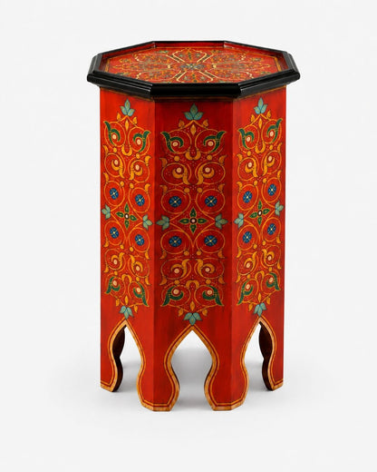 Red Moroccan accent table styled in a warm boho living room 