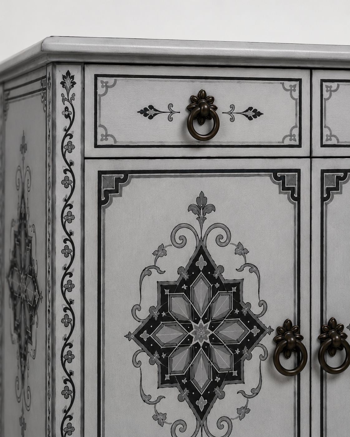 Decorative cabinet with intricate black patterns on a white background